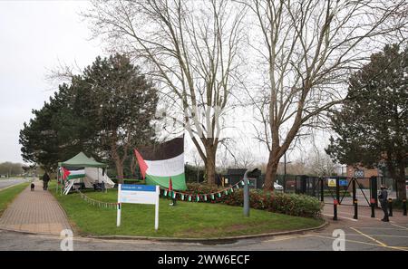 Palestine Action have picked a bell tent and erected a large Palestinian flag as part of a camp directly outside Elbit's offices at Aztec West 600. Supporters of Palestine Action set up a protest camp outside Israeli arms company, Elbit Systems. The protest group have been targeting Elbit Systems at the eight businesses that operate in the UK. The protesters state 85% of drones flying in the Israeli defence force are provided by Elbit. These drones are oppressing Palestinians in Gaza and elsewhere and Palestine Action demand all Elbit Systems businesses in the UK close. As a result of persiste Stock Photo