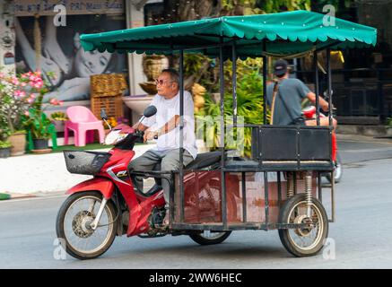 Mae Hong Son province,Northern Thailand-April 10 2023:A strange sight to see,perhaps,in Western countries.But in Asia the motorcycle is a popular way Stock Photo