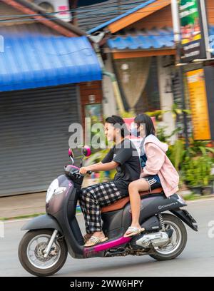 Mae Hong Son province,Northern Thailand-April 10 2023:A strange sight to see,perhaps,in Western countries.But in Asia the motorcycle is a popular way Stock Photo