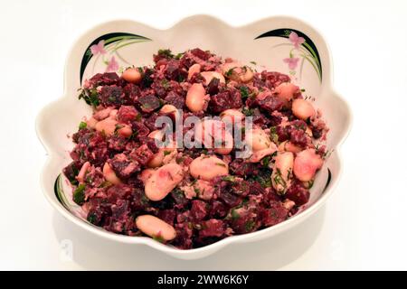 A salad consisting of beets, beans and pieces of tuna fish. Hearty breakfast. Stock Photo