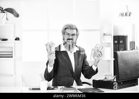 net profit. modern life and business. corporate leather bag. mature man with case at workstation. male office fashion. Businessman hand holding Stock Photo