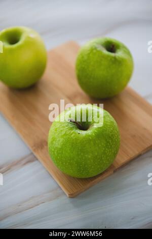 green apples on cutting board Stock Photo