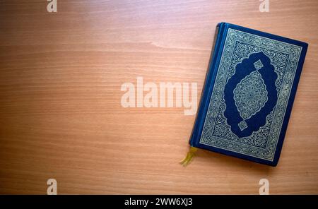 The Qur'an, the holy book of Muslims on a wooden table. Copy space. Stock Photo