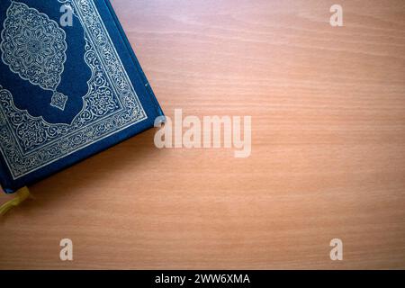 The Qur'an, the holy book of Muslims on a wooden table. Copy space. Stock Photo