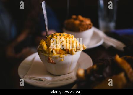 Close-up of melted cheesy pasta in a bowl at a restaurant Stock Photo