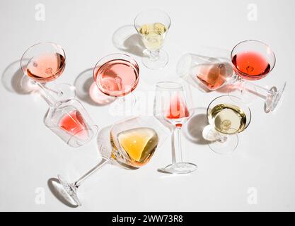 Wine glasses tipped over with red, white, orange and rose wine Stock Photo