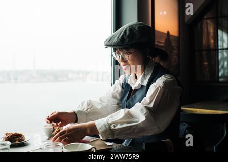 Asian woman having fika in a restaurant in Stockholm Stock Photo