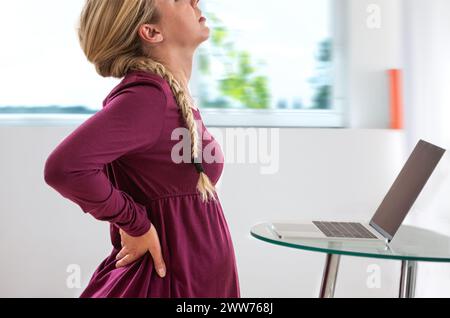 Pregnant woman in profile,with back pain. Stock Photo
