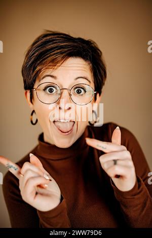 A short-haired woman with glasses posing for the camera Stock Photo