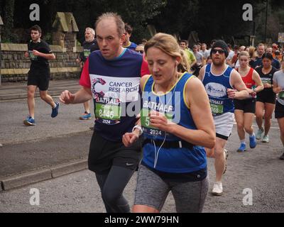 Runners taking part in the Bath Half Marathon 2024, including participants raising funds for Cancer Research UK and Mind Stock Photo