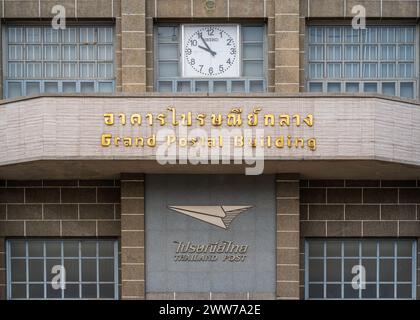 Bangkok, Thailand - 03 19 2024 : Detail view of the facade of historic General Post Office aka Grand Postal Building with clock, name and logo Stock Photo
