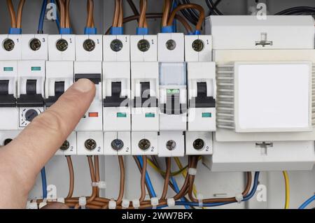 Electrician Testing Circuit Breaker Panel Stock Photo