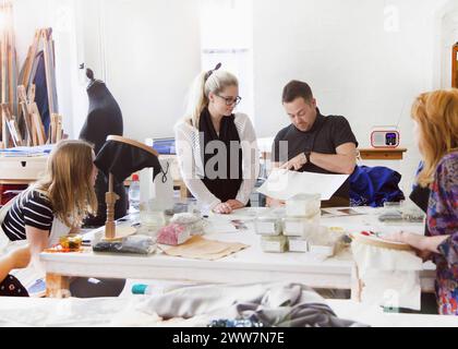 Design Professionals Working at Embroidery Studio Stock Photo