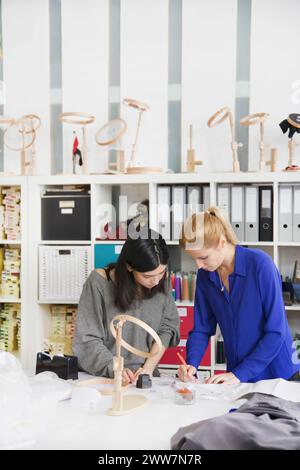 Women Working at Embroidery Design Studio Stock Photo