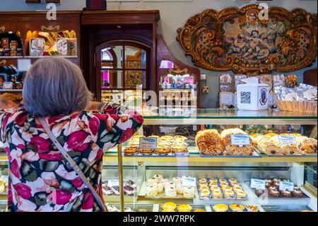 Seville, Spain, Senior Woman from Behind, Food Shopping, inside Traditional Spanish Bakery Shop, in Historic City Center, 'La Campana » Confiteria Stock Photo