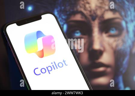 KYIV, UKRAINE - MARCH 17, 2024 Microsoft Copilot logo on iPhone display screen with background of artificial intelligence futuristic ai generated image close up Stock Photo