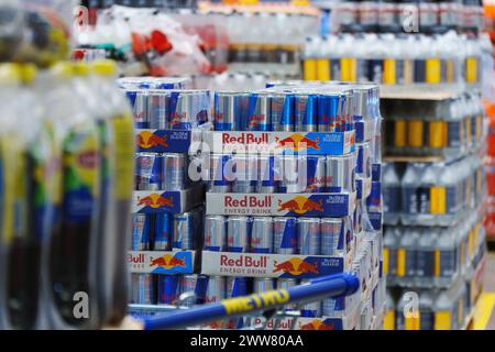 Tyumen, Russia-March 02, 2024: Display in a store is overflowing with cans of Red Bull energy drink, neatly stacked and organized to attract customers Stock Photo