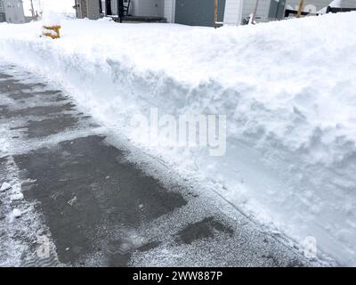 Cleared Pathway Amidst Snowy Suburban Landscape Stock Photo