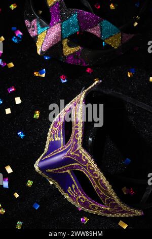 Masquerade mask with confetties on black background. Stock Photo