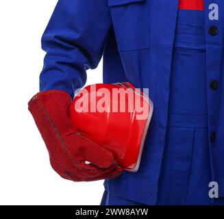Young man holding red hardhat on white background, closeup. Safety equipment Stock Photo