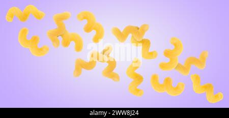 Raw cavatappi pasta falling on violet background Stock Photo