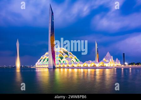 Bandung, Indonesia - 4th Nov 2023: Al Jabbar Great Mosque at night (blue hour) with lamps and reflections in the pond Stock Photo