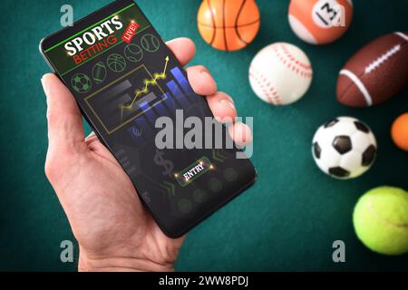 Person consulting online sports information in an app on a smartphone on a table with a green felt mat with objects representative of different sports Stock Photo