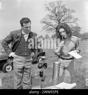 PATRICK MACNEE as John Steed and DIANA RIGG as Emma Peel examine some field equipment in a scene from the A SURFEIT OF H20 episode 8 of the fourth series of THE AVENGERS TV Series first broadcast  on November 16 1965 Director SIDNEY HAYERS Written by COLIN FINBOW Wardrobe JACKIE JACKSON and JEAN MUIR Music LAURIE JOHNSON Associated British Productions for ABC TV Stock Photo