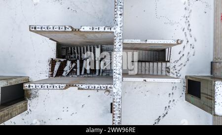 Drone photography of unfinished and abandoned building in a city covered by snow during winter cloudy day Stock Photo