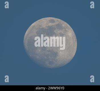London, UK. 22nd Mar, 2024. Waxing Gibbous Moon at sunset over London in clear sky between clouds. Credit: Malcolm Park/Alamy Live News Stock Photo