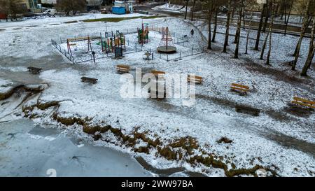 Drone photography of frozen lake and public park covered in snow during ...