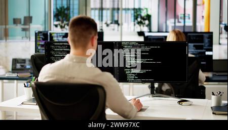 Software Programmer Or Coder Man Using Office Computer Stock Photo