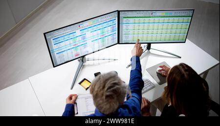 Auditor Employees And Data Analyst Using Computer Spreadsheet Stock Photo