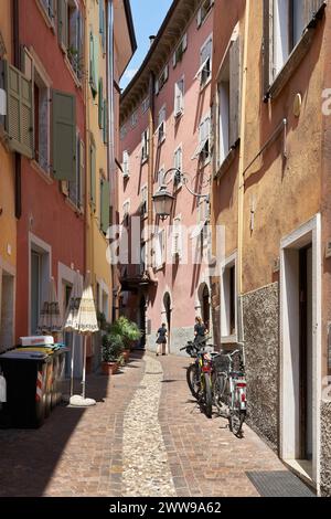 Narrow alley in the popular historic old town of Riva del Garda on Lake Garda in Italy Stock Photo