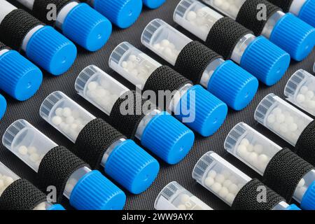 Tubes of homeopathic globules with different homeopathic preparation. Homeopathy first aid kit close up. Stock Photo