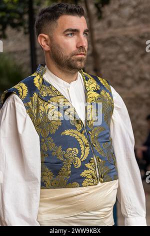 A Portrait of Tradition: Fallas Attire in Full Display. In Gandia’s festive streets, a man’s costume tells a tale of history and celebration. Stock Photo