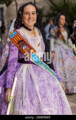 Valencian Vibrance in Gandia’s Festivities: A Fallera’s Costume in Focus. The ensemble, rich with detail, mirrors the spirited essence of the Fallas Stock Photo