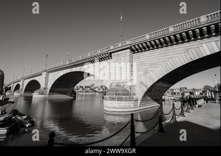 Tourists near the old London Bridge, which was relocated from London England in the 1970’s to Lake Havasu Arizona.  Black and white image. Stock Photo