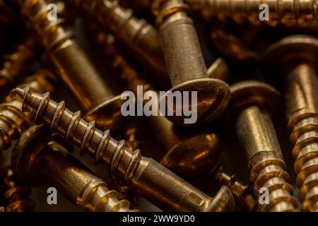 close up of many brass colored screws Stock Photo