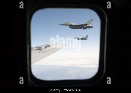 Two F-16 Fighting Falcon aircraft assigned to the 112th Expeditionary Fighter Squadron are seen through the window of a KC-135 Stratotanker aircraft assigned to the 756th Air Refueling Squadron stationed at Joint Base Andrews, Md., during a refueling mission over Ohio, March 19, 2024. The mission was part of an orientation flight for the new Senior Enlisted Advisor to the Chairman of the Joint Chiefs of Staff, Troy E. Black. (U.S. Air Force photo by Airman 1st Class Gianluca Ciccopiedi) Stock Photo