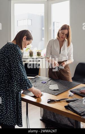 Fashion designers working together in a bright studio Stock Photo
