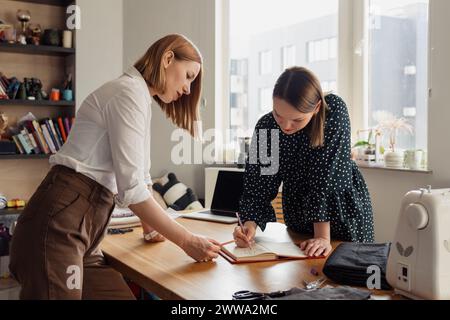 Seamstresses collaborating on a fashion design project Stock Photo