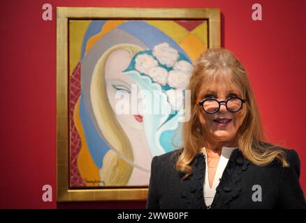 File photo dated 14/3/2024 of Pattie Boyd with La Jeune Fille au Bouquet, by Emile Theodore Frandsen de Schomberg, circa 1950-55, the original painting used as the cover artwork for the 1970 Derek and the Dominos album Layla and Other Assorted Love Songs. A trove of treasures from the former fashion model, including photographs and love letters, have sold for almost £3 million at auction - far exceeding its original estimate. The Pattie Boyd Collection included letters from the time she was involved in a love triangle with former husbands Eric Clapton and George Harrison. Issue date: Saturday  Stock Photo