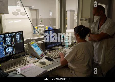 Doctors observing the images of a scanner in the emergency room of a university hospital. Stock Photo