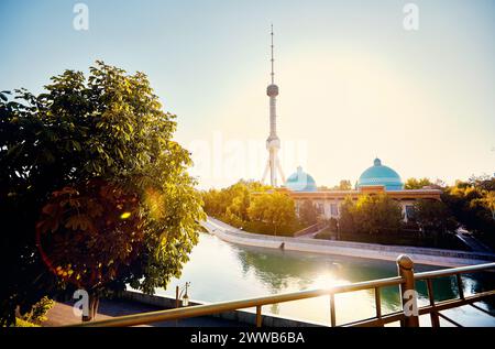 The Tashkent Television TV Tower Toshkent Teleminorasi with reflection in the river from the bridge at sunset in Uzbekistan Stock Photo