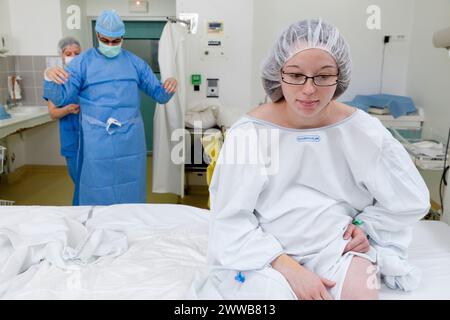 Epidural. Anesthesiologist putting on a sterile gown. Stock Photo