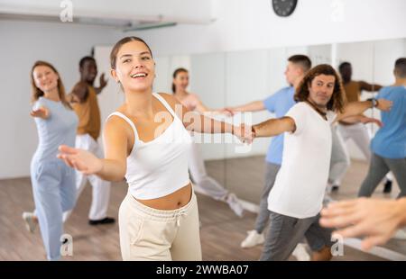 Adult couples dancing active dance together in studio Stock Photo