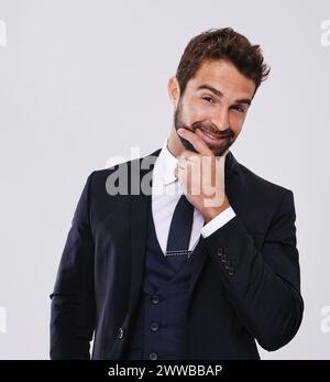 Groom, fashion and formal suit in studio, confident in black tie for wedding event. Elegant, classy male person and hands with blazer or trendy tuxedo Stock Photo