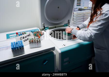 Technical platform of the Inovie 34 laboratory . Lab technician preparing sample tubes for the centrifuge. Stock Photo