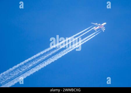 Munich, Germany - February 6, 2024: Emirates Airbus A380-800 airplane with contrails over Munich Airport (MUC) in Germany. Stock Photo